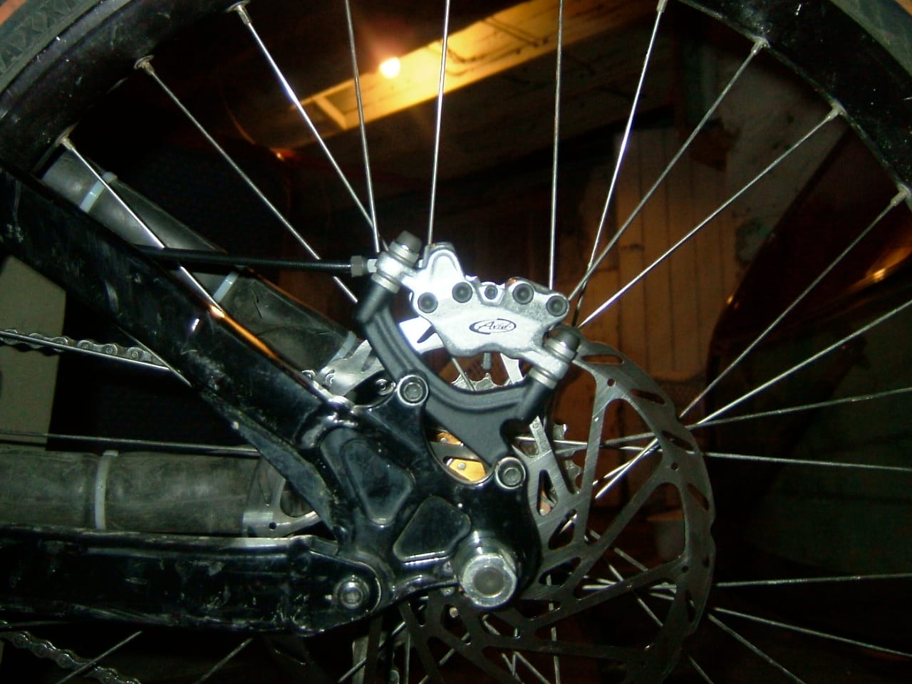 Hydraulic disc brake caliper and rotor on a bicycle wheel