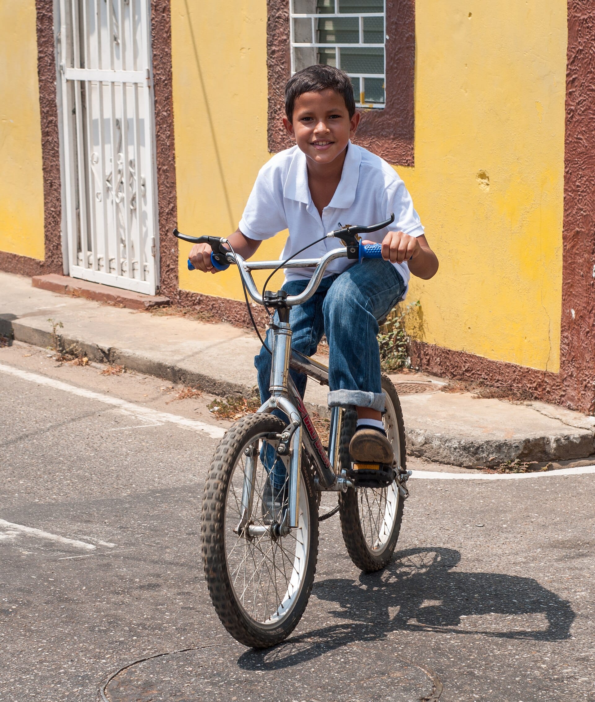 Boy riding a small-wheel kids bike